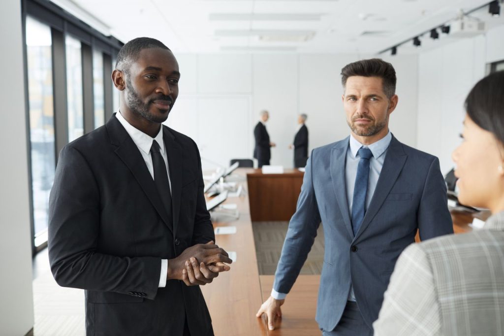 A diverse group of professionals engaged in a business meeting in a modern conference room.